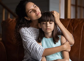 A woman and a girl seated together, representing child custody by non-parent - Aminu Law Firm, PLLC