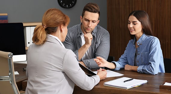 Couple consulting with a professional at an office for legal or financial advice - Aminu Law Firm, PLLC