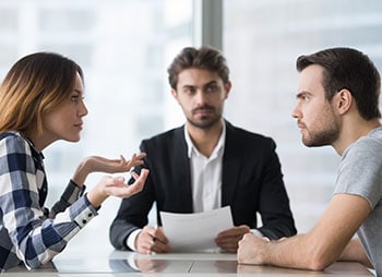 Couple engaged in a conversation about the Discovery Process - Aminu Law Firm, PLLC