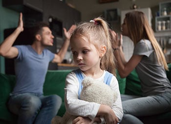 Image representing a Child holds teddy bear as parents argue, showing unfit parent - Aminu Law Firm, PLLC