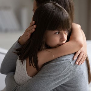 Child hugging parent during emotional custody discussion in a family law case - Aminu Law Firm, PLLC